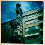 A bird sculpted into the top of a fallen tree