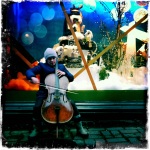 A street performer outside of Stockmann's department store plays the cello.